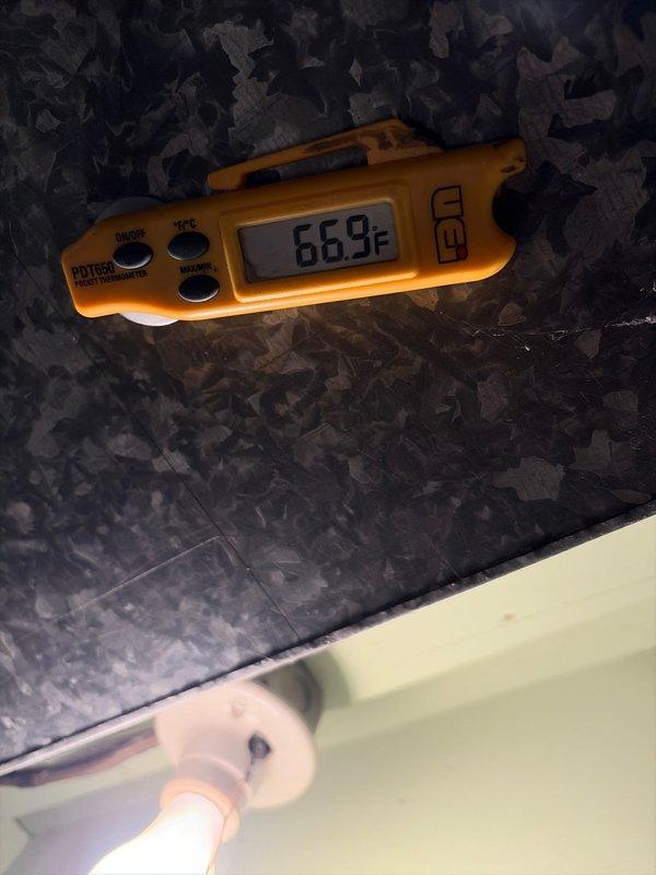 Completed A/C installation with system startup and performance verification. Confirmed proper refrigerant temperatures with supply air reading 66.9°F and refrigerant line temperature at 494°F, indicating successful system operation and heat transfer.