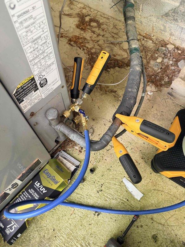Responded to no cooling complaint for family room air conditioning system. Upon arrival, connected manifold gauges to evaluate refrigerant pressures and system operation. Diagnostic assessment performed on aging HVAC unit serving the family room zone to determine cause of cooling failure.