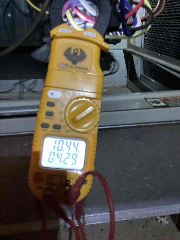 Completed cooling season tune-up on Trane outdoor condensing unit. Performed standard maintenance procedures including electrical diagnostics with multimeter readings, system performance verification, and visual inspection of refrigerant lines and cabinet condition. Unit operational with notable exterior rust staining observed on cabinet panels requiring future monitoring.