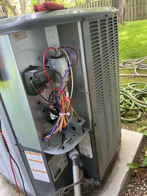 Performed comprehensive cooling system maintenance on residential HVAC unit. Accessed indoor blower motor assembly and inspected all electrical connections, wiring, and mounting hardware for proper operation. Removed outdoor condensing unit access panel to examine capacitor, contactor, and electrical components, verifying all connections were secure and functioning within specifications.