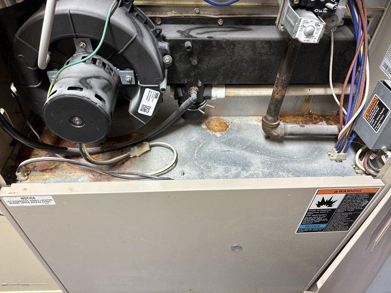 Conducted comprehensive evaluation of existing HVAC system for full replacement options. Inspected furnace unit revealing significant rust and corrosion on internal components, including deteriorated floor pan, corroded piping, and aging blower motor assembly. Documented basement utility room installation conditions and current equipment configuration to provide accurate replacement system recommendations and sizing requirements.