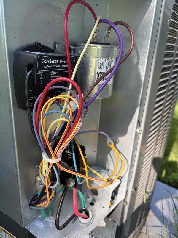Completed routine HVAC cooling maintenance on outdoor condensing unit and air handler system. Inspected electrical components including CoreSense diagnostic module for Copeland scroll compressor, verified capacitor condition and connections, examined all wiring and control circuits for proper operation, and replaced air filtration media. All components found in good working condition with no deficiencies noted.