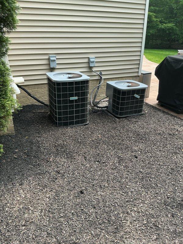 Completed full HVAC system replacement for upstairs zone, including installation of new International Comfort Products evaporator coil in mechanical room and dual outdoor condensing units positioned on gravel pad with proper electrical disconnects and refrigerant line connections. All components installed per manufacturer specifications with appropriate drainage and condensate lines.