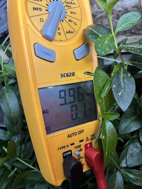 Responded to service call for water accumulation beneath indoor furnace unit during air conditioning operation. Upon arrival, performed diagnostic assessment of aging HVAC system. Inspected outdoor condensing unit and verified operational status. Conducted electrical testing using digital multimeter, obtaining voltage and capacitance readings to assess system performance. Identified condensate drainage issue causing water formation at indoor unit. System evaluated and customer advised of findings regarding older equipment condition.