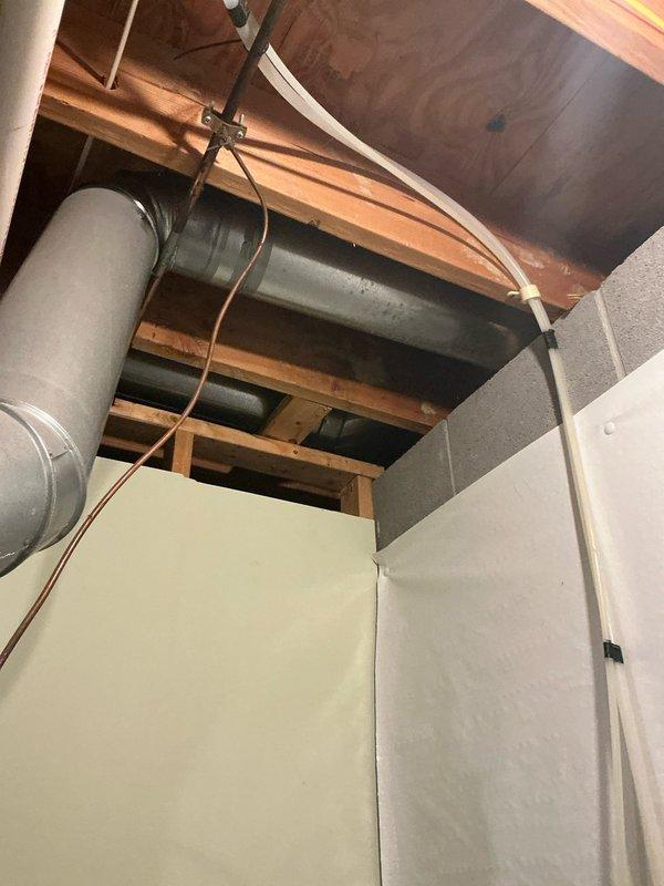 Conducted estimate consultation for upstairs air conditioning system replacement. Property has two separate HVAC systems requiring evaluation. Inspected existing equipment and ductwork configuration in attic space, documenting current system layout including galvanized metal ductwork, copper refrigerant lines, and electrical connections routed through ceiling joists. Assessed wall-mounted General brand humidifier unit with water supply line and electrical connections integrated into existing system. Photographed mechanical components and infrastructure to provide replacement options for aging equipment. Presented multiple system replacement solutions tailored to dual-zone configuration requirements.