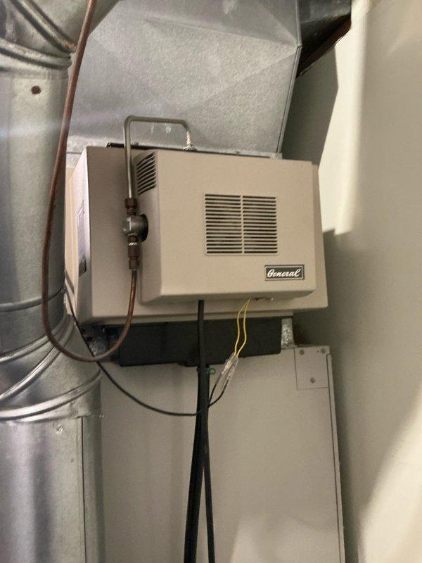 Conducted estimate consultation for upstairs air conditioning system replacement. Property has two separate HVAC systems requiring evaluation. Inspected existing equipment and ductwork configuration in attic space, documenting current system layout including galvanized metal ductwork, copper refrigerant lines, and electrical connections routed through ceiling joists. Assessed wall-mounted General brand humidifier unit with water supply line and electrical connections integrated into existing system. Photographed mechanical components and infrastructure to provide replacement options for aging equipment. Presented multiple system replacement solutions tailored to dual-zone configuration requirements.