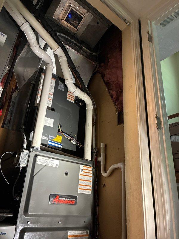 Completed full HVAC system installation including 97% efficiency Amana S-Series furnace, air conditioning unit, and air scrubber system financed through Service Finance. Installation included proper venting with white PVC piping, gas line pressure testing showing correct zero reading on gauge, electrical panel integration with dedicated breaker protection, and digital thermostat control mounting. All components installed to manufacturer specifications with appropriate safety labeling and code-compliant connections in utility closet location.