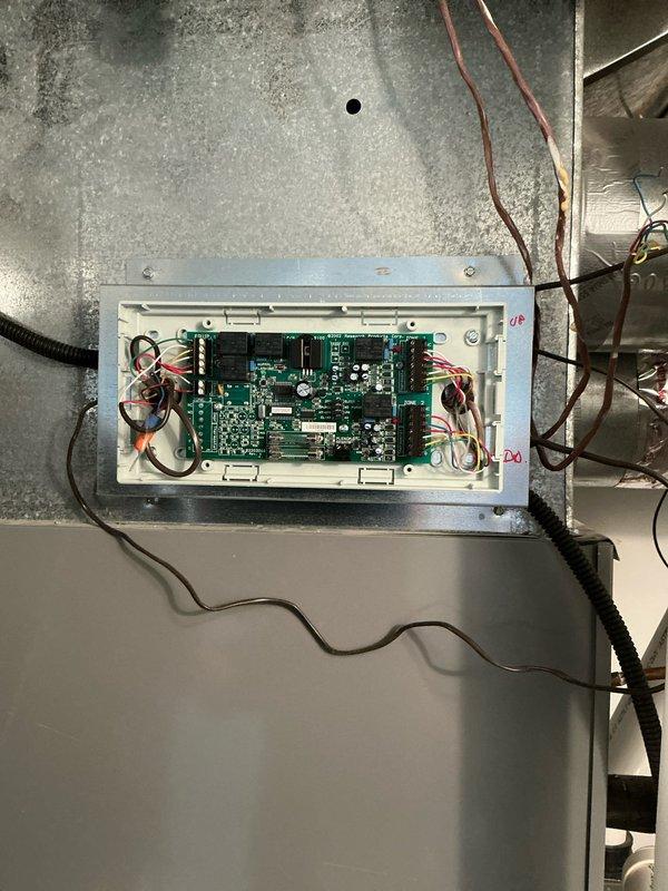 Conducted comprehensive evaluation of existing zoned HVAC system to provide furnace replacement options. Documented current system configuration including zone control board with multiple wire connections and main heating unit with associated ductwork and damper components to determine compatibility requirements for new equipment installation.