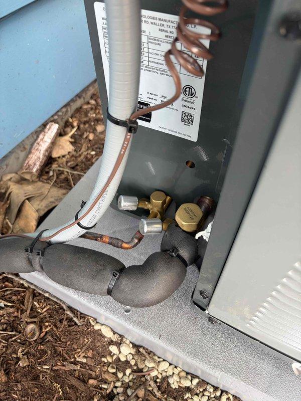 Completed installation of new air conditioning system including outdoor condensing unit and indoor air handler. Connected refrigerant lines, electrical wiring, and condensate drainage with proper insulation and secure mounting on concrete pad with leveling blocks. System tested and verified operational with all components functioning within manufacturer specifications.