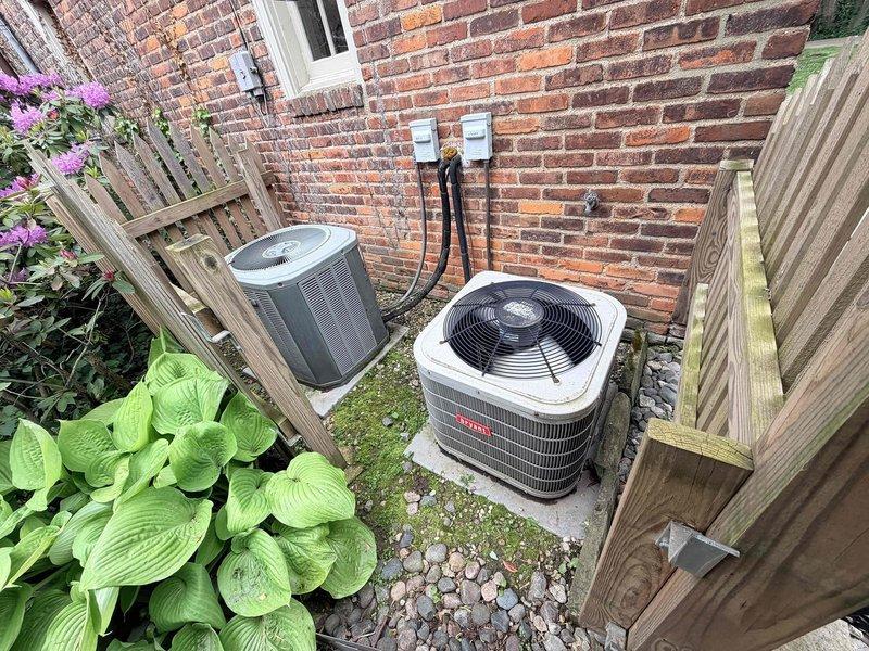 Responded to service call for two non-operational AC units, with one producing noise and no cooling. Performed diagnostic assessment on both Bryant condenser units located in side yard installation. Inspected electrical disconnects, conduit connections, and outdoor equipment for both systems to identify failure points and determine necessary repairs.