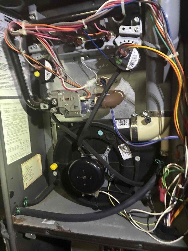 Performed routine heating and cooling maintenance on two HVAC systems. Conducted thorough inspection of furnace internal components including blower motor assembly, gas valve, electrical connections, and wiring harnesses, verifying all connections were secure and components operating within normal parameters. Inspected outdoor condensing unit, confirming fan operation and checking condenser coil condition through protective grille.