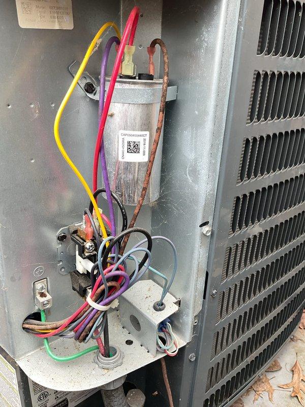# HVAC Cooling Maintenance Summary

Completed scheduled preventive maintenance on residential air conditioning system. Performed comprehensive inspection of outdoor condenser unit, including electrical components, capacitor, contactor assembly, and refrigerant connections. All components found to be operating within normal parameters with no immediate service needs identified.

# Detailed Work Performed

Conducted thorough visual and operational inspection of outdoor condensing unit positioned on concrete pad with river rock landscaping. Verified proper electrical connections at disconnect box and traced conduit to unit. Inspected exterior cabinet condition, noting normal weathering consistent with outdoor installation.

Removed and secured access panel to evaluate internal electrical components. Performed detailed inspection of dual-run capacitor, noting age-related discoloration on metal casing and mounting hardware consistent with normal outdoor exposure. Verified all wire terminati
