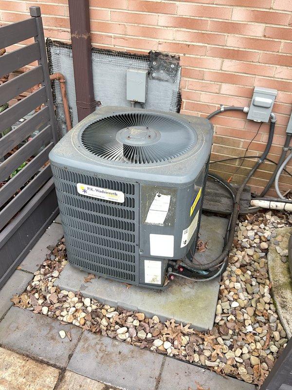 # HVAC Cooling Maintenance Summary

Completed scheduled preventive maintenance on residential air conditioning system. Performed comprehensive inspection of outdoor condenser unit, including electrical components, capacitor, contactor assembly, and refrigerant connections. All components found to be operating within normal parameters with no immediate service needs identified.

# Detailed Work Performed

Conducted thorough visual and operational inspection of outdoor condensing unit positioned on concrete pad with river rock landscaping. Verified proper electrical connections at disconnect box and traced conduit to unit. Inspected exterior cabinet condition, noting normal weathering consistent with outdoor installation.

Removed and secured access panel to evaluate internal electrical components. Performed detailed inspection of dual-run capacitor, noting age-related discoloration on metal casing and mounting hardware consistent with normal outdoor exposure. Verified all wire terminati