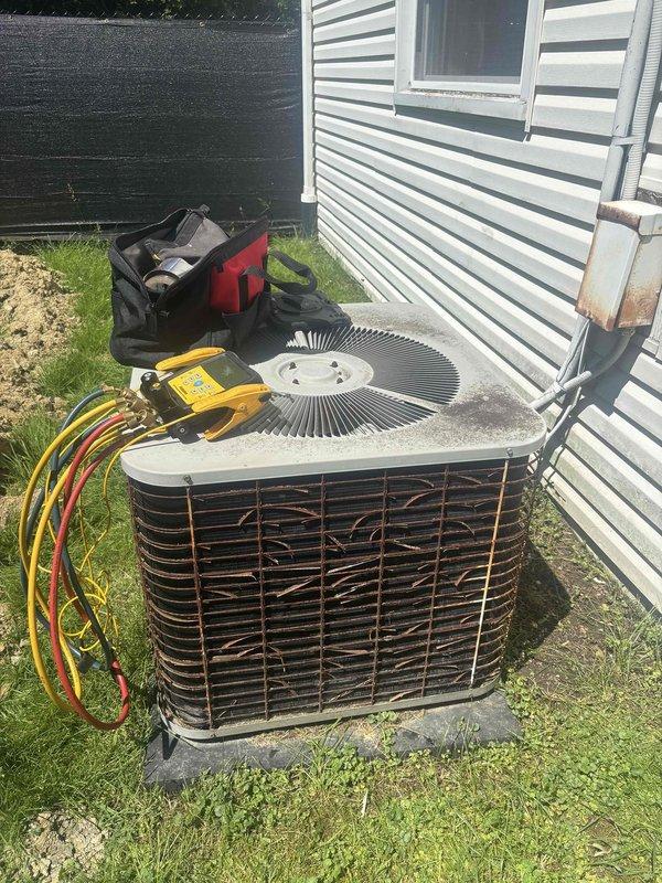 Performed comprehensive preventive maintenance inspection on aging outdoor condensing unit for residential cooling system. Conducted electrical diagnostics using multimeter to verify proper voltage and amperage to compressor and fan motor, tested capacitor performance, and evaluated overall system operation. Inspected condenser coil condition through protective grilles, noting weathering and dirt accumulation typical of outdoor exposure, and assessed refrigerant line connections for integrity. Unit demonstrated functional operation despite age-related wear, with all major components performing within acceptable parameters at time of service.