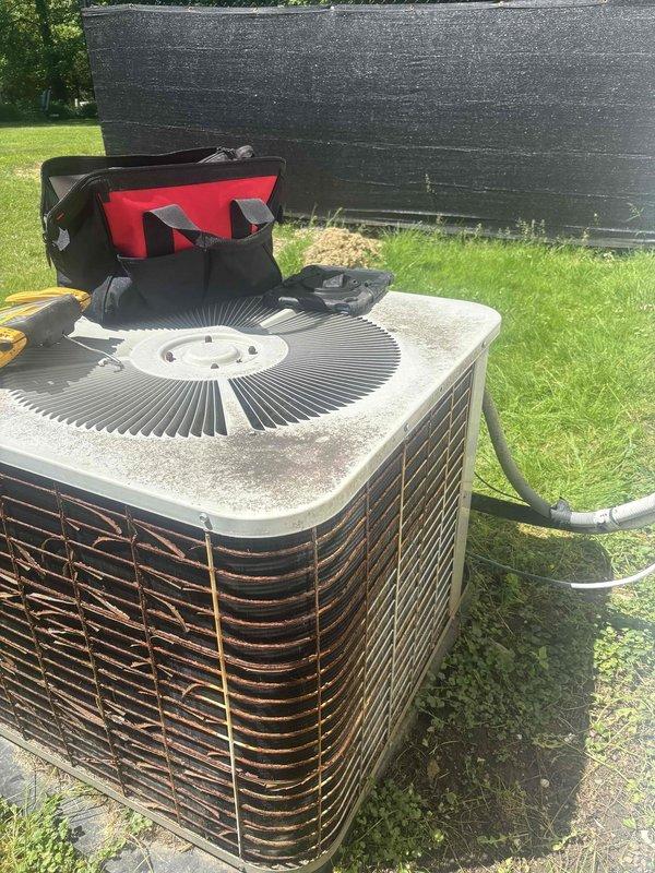 Performed comprehensive preventive maintenance inspection on aging outdoor condensing unit for residential cooling system. Conducted electrical diagnostics using multimeter to verify proper voltage and amperage to compressor and fan motor, tested capacitor performance, and evaluated overall system operation. Inspected condenser coil condition through protective grilles, noting weathering and dirt accumulation typical of outdoor exposure, and assessed refrigerant line connections for integrity. Unit demonstrated functional operation despite age-related wear, with all major components performing within acceptable parameters at time of service.