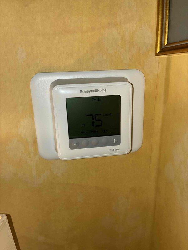 Completed installation of new air conditioning system including outdoor condensing unit and indoor evaporator coil integrated with existing furnace. Installed Honeywell Home ProSeries digital thermostat for system control and programming. Verified proper refrigerant charge, tested all electrical connections, confirmed adequate airflow through ductwork, and ensured proper condensate drainage through existing PVC piping system.