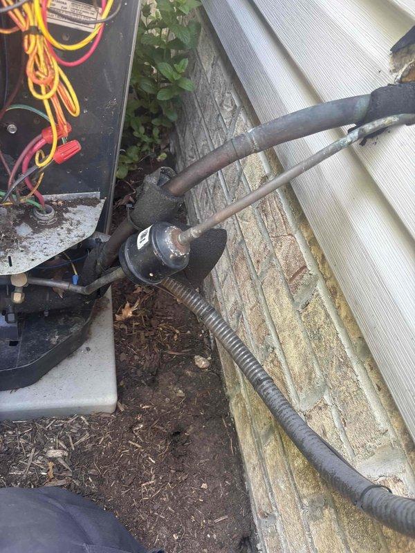Performed routine cooling system maintenance on residential HVAC unit. Inspected outdoor condenser unit, refrigerant lines, and electrical connections, confirming all components operational. Evaluated air filter condition in return air housing, noting accumulated dust and debris from normal operation, with filter media showing adequate airflow capacity for continued use.