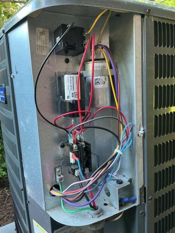 Performed comprehensive cooling system maintenance on outdoor condensing unit and indoor air handler. Accessed electrical compartment to inspect contactor, capacitor, and control wiring connections; verified all electrical components functioning properly with no signs of wear or loose connections. Inspected blower wheel assembly and heat exchanger coil, confirming proper operation and airflow with normal dust accumulation present.