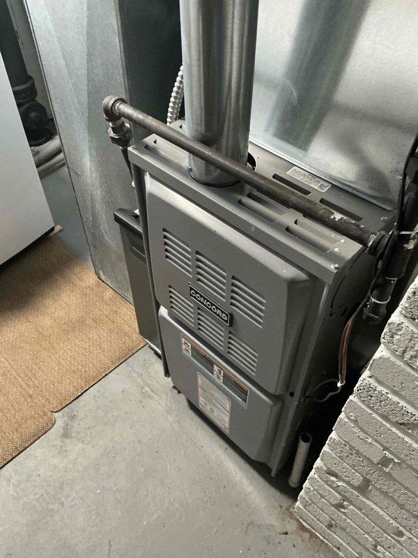 Conducted HVAC system evaluation and provided replacement options for existing furnace and air conditioning equipment. Customer expressed interest in available promotions for complete system upgrade. Documented current equipment configuration including basement-installed furnace with standard ductwork connections and existing refrigerant line routing through ceiling space.