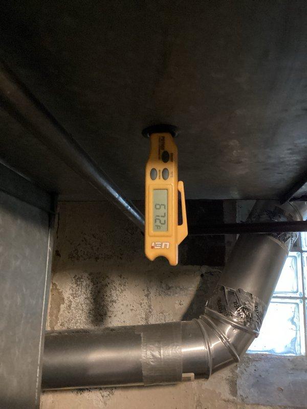Completed routine cooling system maintenance and performance verification. Measured supply air temperatures at ductwork and evaporator coil, recording readings of 57.5°F at the main supply duct and 52.8°F at the coil outlet, confirming proper system operation and adequate temperature differential. Inspected internal components including evaporator coil, blower assembly, and refrigerant lines for proper condition and operation.