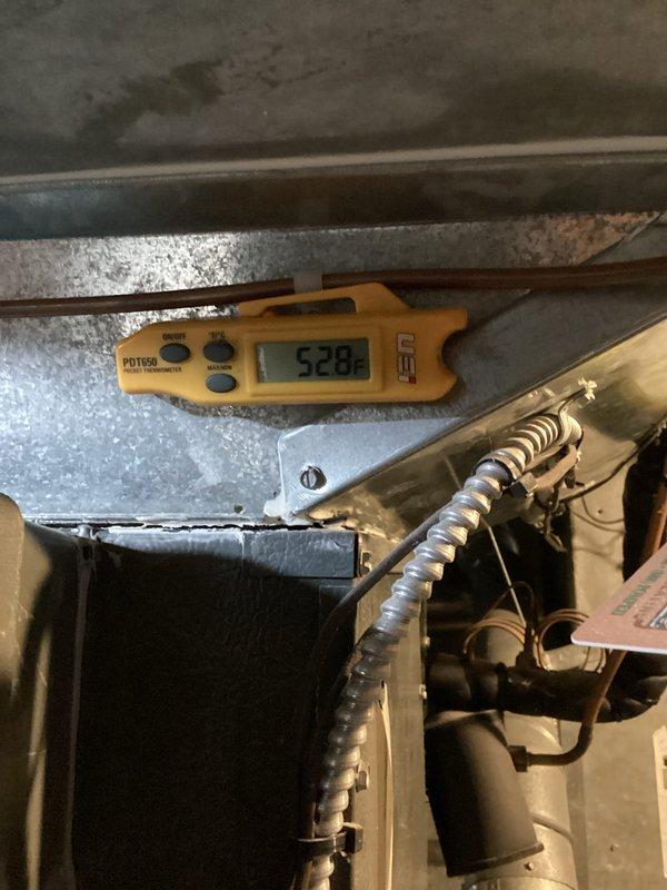 Completed routine cooling system maintenance and performance verification. Measured supply air temperatures at ductwork and evaporator coil, recording readings of 57.5°F at the main supply duct and 52.8°F at the coil outlet, confirming proper system operation and adequate temperature differential. Inspected internal components including evaporator coil, blower assembly, and refrigerant lines for proper condition and operation.