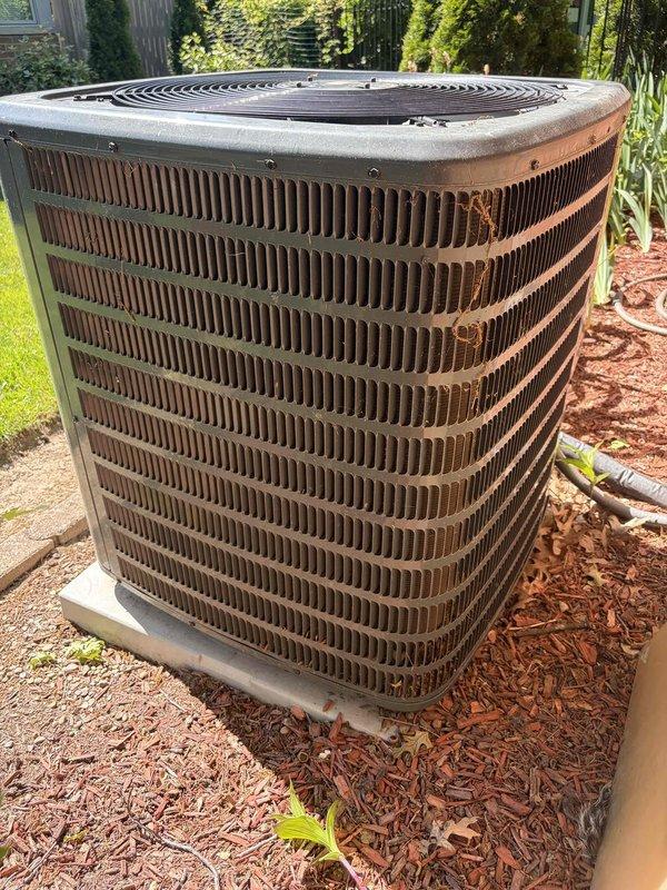 Performed comprehensive cooling system maintenance on residential outdoor condensing unit. Inspected condenser coils, which showed moderate oxidation and weathering consistent with unit age, confirmed proper airflow clearance, and verified refrigerant line insulation integrity. Removed access panel to inspect electrical components including dual capacitors, confirmed all wire connections secure at terminals, and verified proper operation of internal mechanical systems.