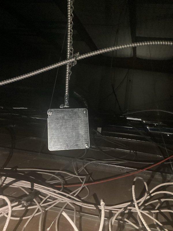 Disconnected power supply to table equipment at ceiling level. Located and isolated the electrical junction box in the ceiling space, removed the metal cover plate, and safely disconnected the wiring feeding the table power circuit. Secured all exposed conductors and reinstalled the junction box cover to maintain code compliance.