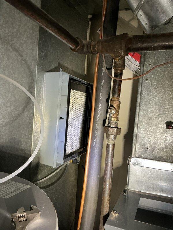 Installed Aprilaire 700 whole-home humidifier and air scrubber system to existing HVAC equipment. Connected humidifier to water supply via copper piping with brass fittings and integrated unit with forced air system through proper ductwork connections. Mounted and wired control panel with digital display for system operation and humidity monitoring, completing full installation with all electrical and plumbing connections secured per manufacturer specifications.
