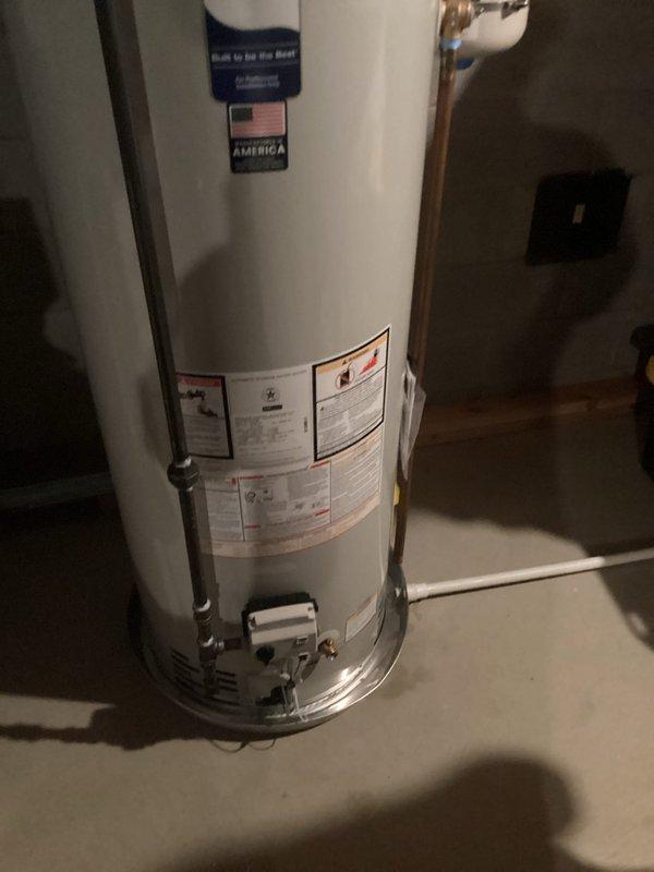 Responded to service call for non-functioning Bradford White tanked water heater with no hot water production. Upon inspection, assessed existing 40-50 gallon conventional tank water heater installation in basement mechanical room, including copper supply lines, PVC venting system through exterior wall, expansion tank, and gas supply connections. Customer expressed interest in converting from traditional tank system to tankless water heater technology. Documented current equipment configuration, plumbing connections, venting arrangement, and available space for potential tankless conversion, photographing existing installation for replacement planning and estimate preparation.
