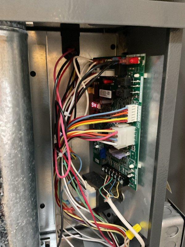 # HVAC Heating System Maintenance Completed

Performed comprehensive first-year heating system maintenance on residential HVAC unit. Conducted thorough inspection of control board assembly, verifying proper operation of dual green circuit boards with digital display readouts and confirming all electrical connections, wire terminals, and connector blocks were secure throughout the control panel enclosure. Inspected complete ductwork network including galvanized metal supply and return ducts, elbow joints, and connection points for proper airflow and structural integrity. Examined air filtration system and verified filter condition. All system components found operating within normal parameters with no immediate service needs identified.