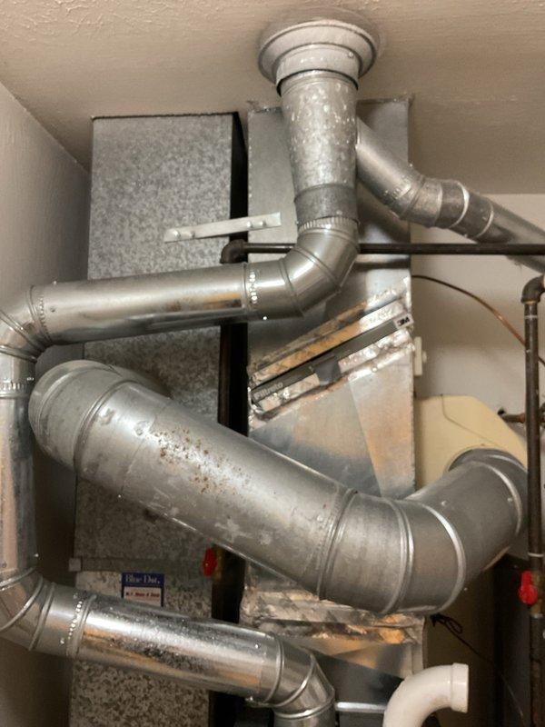 # HVAC Heating System Maintenance Completed

Performed comprehensive first-year heating system maintenance on residential HVAC unit. Conducted thorough inspection of control board assembly, verifying proper operation of dual green circuit boards with digital display readouts and confirming all electrical connections, wire terminals, and connector blocks were secure throughout the control panel enclosure. Inspected complete ductwork network including galvanized metal supply and return ducts, elbow joints, and connection points for proper airflow and structural integrity. Examined air filtration system and verified filter condition. All system components found operating within normal parameters with no immediate service needs identified.