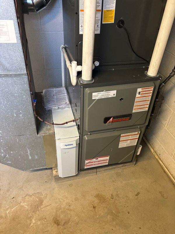 Completed full HVAC system installation in basement mechanical room including 96% efficiency furnace, air conditioning system, and Aprilaire whole-home humidifier. Installed all necessary condensate drain lines using white PVC piping, connected electrical service, mounted humidity control panel on wall with proper wiring, and integrated all components with existing ductwork. System tested and verified operational with all safety labels properly affixed and equipment secured to manufacturer specifications.
