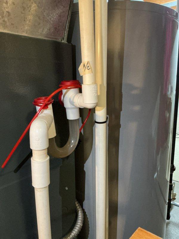 Performed comprehensive AC tune-up on a three-year-old cooling system with no reported issues. Conducted standard preventive maintenance including inspection of air handler components, verified proper airflow, examined pleated air filter condition, and checked refrigerant lines and connections. Inspected condensate drain system with PVC piping assembly, confirmed proper drainage operation, and documented all equipment conditions through photography for maintenance records.