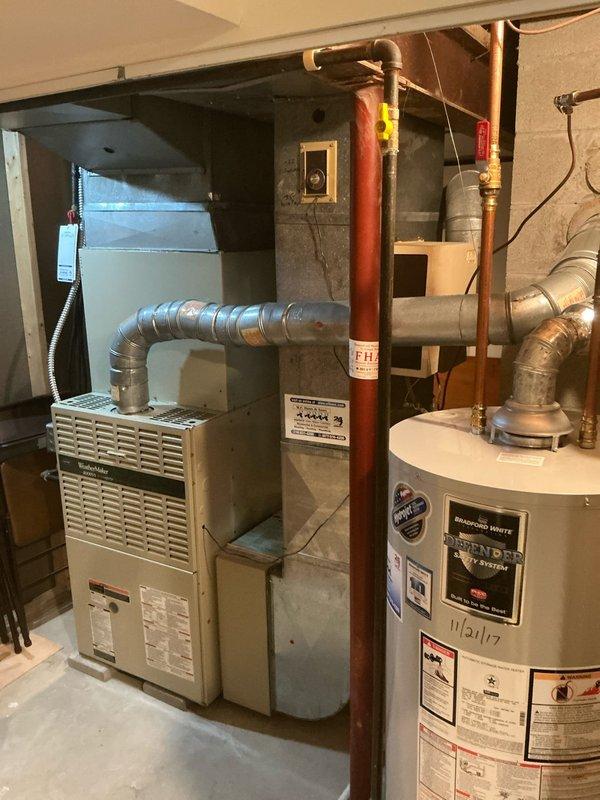 Conducted comprehensive evaluation of existing HVAC system for full replacement estimate. Assessed outdoor condensing unit located on exterior with adequate clearance and access from mulched service area. Evaluated indoor furnace and air handler configuration in basement mechanical room, noting current ductwork connections and available space for new equipment installation. Documented existing electrical disconnect, conduit routing, and power supply infrastructure. Photographed current system layout including furnace positioning adjacent to water heater, existing flexible ductwork runs, and overall equipment accessibility. Provided customer with multiple full system replacement options based on equipment age, configuration, and straightforward installation conditions with favorable access points for both indoor and outdoor components.