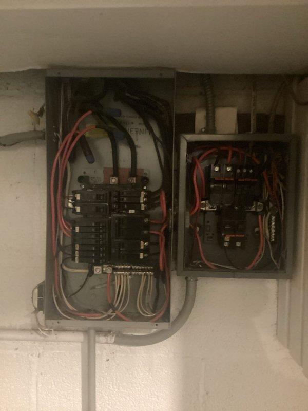 Completed electrical panel assessment for customer considering air conditioning installation. Evaluated existing main panel and sub-panel configuration, documented current breaker layout and capacity, photographed electrical infrastructure including bus bar connections and circuit distribution. Assessed available amperage and determined panel replacement requirements to support additional AC load demands. Provided detailed estimate for panel upgrade to accommodate future HVAC system integration.