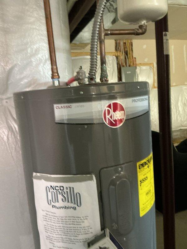 Responded to service call for furnace making extremely loud noise. Upon arrival, inspection revealed the photos captured were of a water heater rather than the furnace system. Water heater exhibited significant rust and corrosion on top surface around pipe connections, with deteriorated condition of unit noted. No furnace service was documented or performed during this visit.