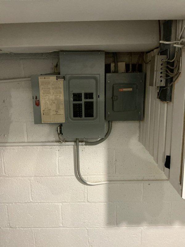 Conducted on-site evaluation for air conditioning system installation as an add-on to existing HVAC setup in residential basement utility area. Assessed electrical infrastructure including current panel configuration and conduit routing to determine compatibility and capacity for new AC unit integration with existing green-cabinet furnace and ductwork system, with proposal to bundle electrical panel upgrade work alongside air conditioning installation pending customer approval.