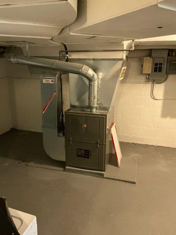 Conducted on-site evaluation for air conditioning system installation as an add-on to existing HVAC setup in residential basement utility area. Assessed electrical infrastructure including current panel configuration and conduit routing to determine compatibility and capacity for new AC unit integration with existing green-cabinet furnace and ductwork system, with proposal to bundle electrical panel upgrade work alongside air conditioning installation pending customer approval.