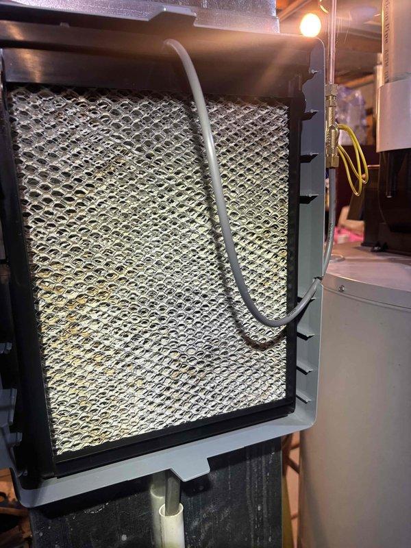 # HVAC Maintenance - Cooling System Service

Performed comprehensive routine maintenance on residential air conditioning system. Upon arrival, customer reported system operating properly with no immediate concerns. System age unknown at time of service.

## Work Performed

Conducted complete AC tune-up protocol including visual inspection of all accessible components. Inspected air filter assembly located in mechanical area, noting honeycomb-style media filter properly installed in frame with secure fastening tabs. Filter condition assessed and found acceptable for continued operation.

Performed electrical diagnostics using digital multimeter to verify proper voltage, amperage, and resistance values across system components. Tested control board connections and wiring harnesses to ensure secure electrical connections and proper signal transmission. All electrical measurements recorded within manufacturer specifications.

Inspected condensate drainage system including PVC drain lines f