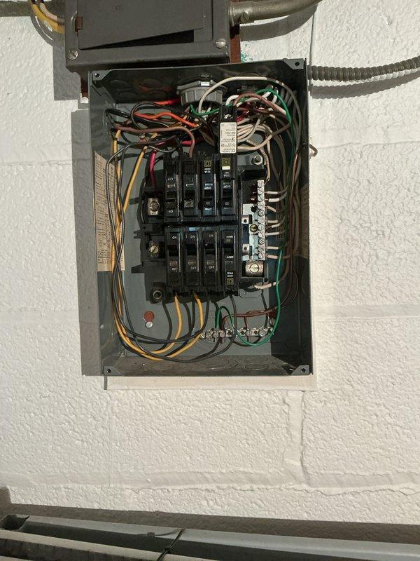 Performed comprehensive electrical inspection of residential main service panel to assess compatibility and requirements for whole home surge protection device installation. Documented existing panel configuration, including circuit breaker layout, wire routing, and available space for surge protector integration. Panel examination revealed standard residential setup with dual-column breaker arrangement and multiple branch circuits entering through top-mounted conduits. Evaluated electrical infrastructure to determine optimal surge protection solution and installation approach for customer consideration.