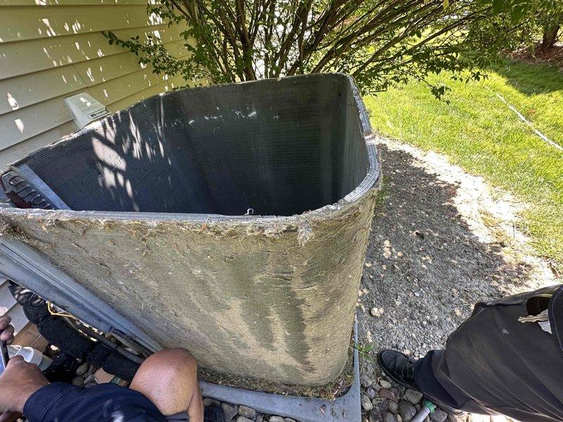 Returned to complete repair work on outdoor condensing unit. Replaced failed condenser fan motor, run capacitor, and contactor. Installed hard start kit to assist compressor during startup cycles. Performed thorough coil cleaning to remove heavy accumulation of dirt, debris, and organic material that had significantly restricted airflow. Cleared vegetation encroaching on unit to restore proper clearance for adequate ventilation and future serviceability. Unit tested and confirmed operational upon completion.