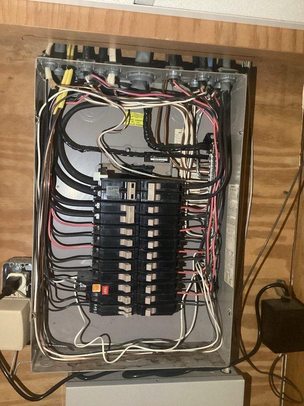 Conducted comprehensive electrical inspection of residential service entrance and main distribution panel. Documented exterior meter installation, verifying proper mounting of meter base, conduit connections, and meter socket housing with digital smart meter. Inspected interior main electrical panel, confirming proper circuit breaker arrangement, bus bar connections, and wire routing. Verified color-coded conductor organization, grounding connections, and panel labeling compliance with electrical code requirements.