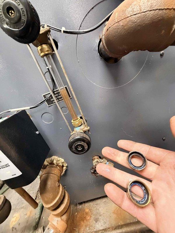 Responded to service call for boiler sight glass leak. Upon inspection, confirmed active leak at sight glass assembly due to deteriorated O-ring seals. Disassembled sight glass unit, removed failed gaskets, and installed new O-ring seals on both mounting points. Reassembled sight glass assembly, verified proper seating of all components, and pressure-tested system to confirm leak was eliminated and boiler returned to normal operation.