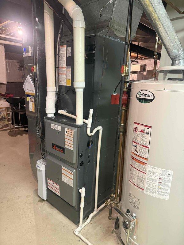 Completed full HVAC system installation including 96% efficiency Amana furnace, air conditioning unit, and lineset in basement mechanical room. Installed white PVC venting system for high-efficiency furnace exhaust and intake, routed metallic ductwork through ceiling infrastructure, and established all necessary electrical connections and condensate drainage. System tested and operational with all equipment properly labeled and safety controls verified.