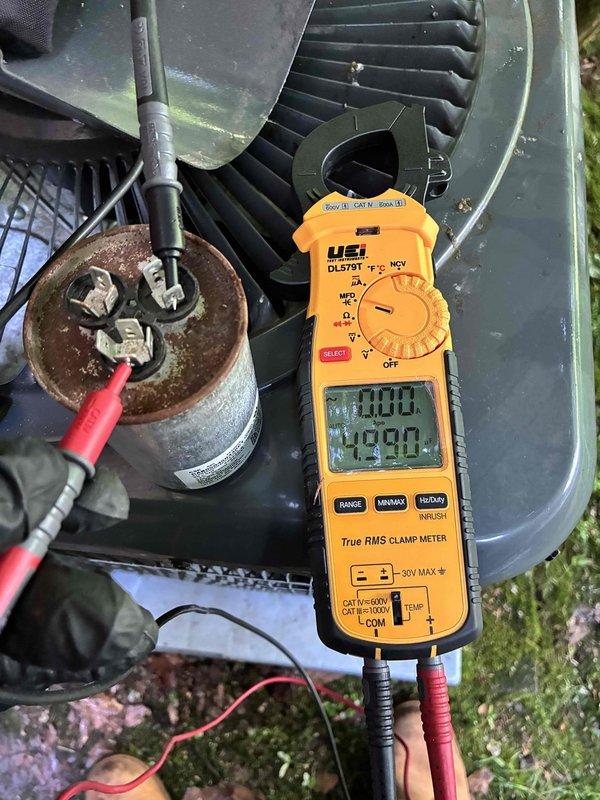 Completed scheduled cooling maintenance on two HVAC systems. Performed comprehensive diagnostic testing using digital clamp meter to verify electrical performance, measuring amperage draws and voltage levels at both outdoor units. Inspected condensing units including fan assemblies, capacitors, and electrical connections. Documented system readings showing proper voltage at 115.1V and normal operating amperages. Noted existing capacitor showing surface corrosion but functioning within acceptable parameters. Verified all electrical connections secure and system components operating as designed. Both systems tested and confirmed operational for continued cooling season performance.