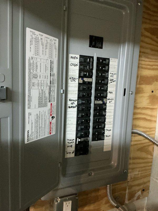 Responded to service call for residential air conditioning system found to be completely flat on refrigerant. Upon inspection, determined that the existing HVAC equipment, including both the indoor air handler and outdoor condensing unit, are original to the home and have reached the end of their serviceable life expectancy. Evaluated the electrical service panel and existing equipment configuration in the basement utility area. Provided comprehensive replacement options to the homeowner, including system sizing recommendations and equipment specifications appropriate for the application. Documented existing conditions with photographs of the current air handler unit showing copper refrigerant lines and the electrical breaker panel with circuit identification. Recommended full system replacement due to age of equipment and loss of refrigerant charge, as repair would not be cost-effective given the overall condition and age of the components.