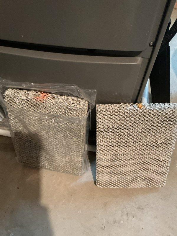 Completed routine HVAC cooling system maintenance on residential heat pump unit. Inspected outdoor condenser unit, noting dust and debris accumulation on coil surfaces; cleaned and serviced air filter assembly to restore proper airflow. Replaced humidifier filter pads with new units to ensure optimal humidity control and indoor air quality for the upcoming season.