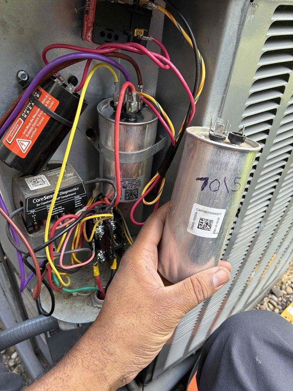 Replaced failed condenser fan motor and dual-run capacitor on outdoor HVAC unit. Removed access panel to diagnose system malfunction, disconnected faulty motor and capacitor assembly, and installed new components with proper electrical connections. Verified all wire terminations were secure, tested capacitor ratings matched system specifications, and confirmed proper operation of condensing unit before restoring power and closing access panel.