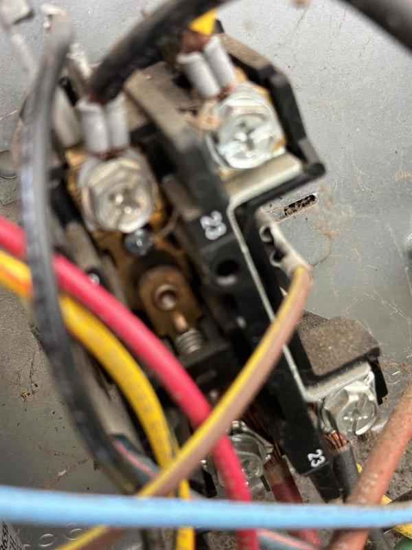 Completed scheduled preventive maintenance on residential cooling system. Inspected electrical contactor assembly, noting oxidation and wear on contact points consistent with normal operation. Verified all wire connections secure at terminals with proper phase wiring intact. Examined air return ventilation grille, confirming adequate airflow and proper slat alignment. System operational and functioning within normal parameters upon completion of maintenance visit.