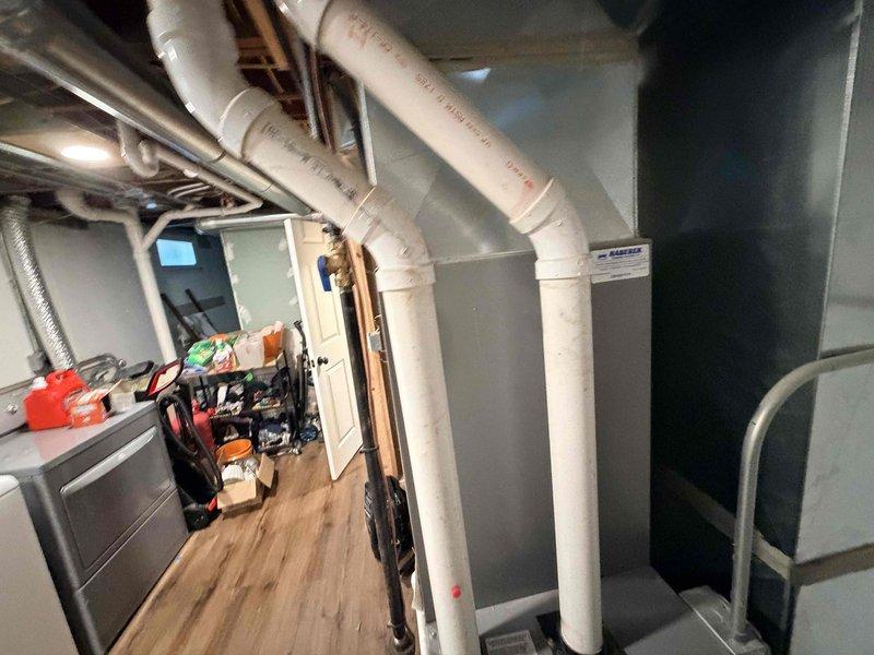 Completed comprehensive cooling system maintenance on residential HVAC unit located in basement mechanical room. Performed thorough inspection of condenser unit, which showed significant dirt and debris accumulation on fan motor assembly and interior surfaces. Cleaned condenser coils, fan blades, and housing to restore optimal airflow and heat transfer efficiency. Verified electrical connections at terminal blocks, inspected refrigerant lines for proper insulation and potential leaks, and confirmed all copper tubing connections were secure. Removed organic debris from fan guard and surrounding areas. System tested and operating within normal parameters following maintenance procedures.